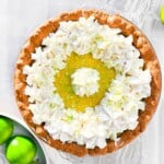 Key lime pie with a bowl of limes next to it.