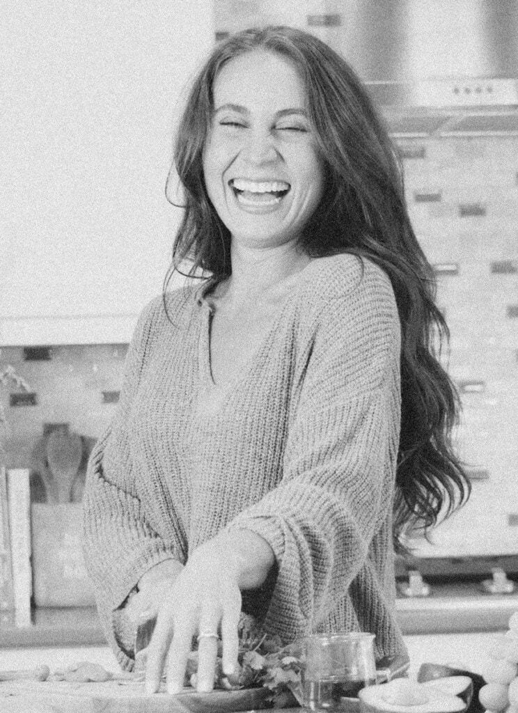 Emmy chopping ingredients in the kitchen.