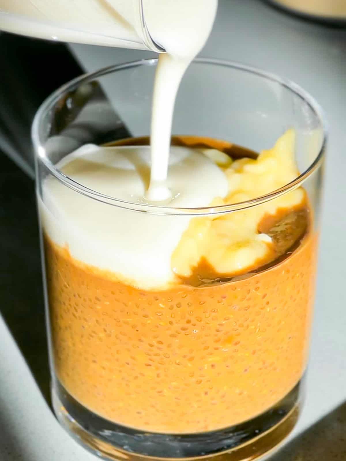 Creamer being poured on chia coffee.