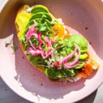 Cottage cheese and avocado toast with pickled onions and micro greens.