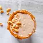 Peanut Butter Smoothie in a cup topped with peanut butter.