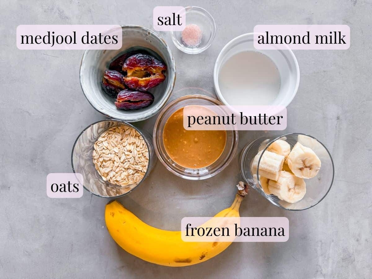 Ingredients for peanut butter banana smoothie in bowls and labeled.