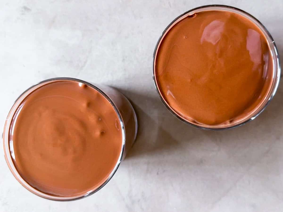 Blended chocolate mousse poured into 2 cups.