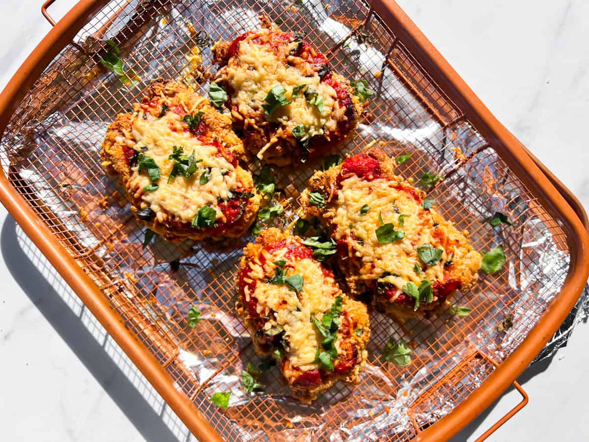 Gluten free chicken parmesan on a baking rack.