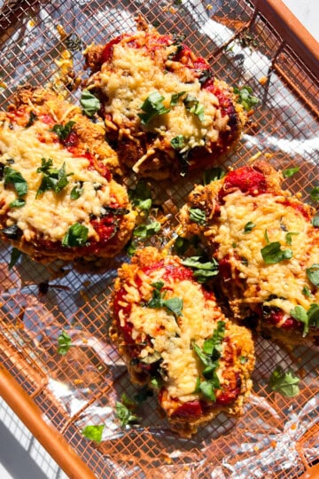 Finished gluten-free chicken parmesan on a wire rack.