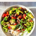 Finished teriyaki beef bowls in cream bowl.