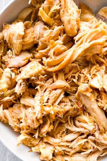 Dutch oven shredded chicken on a white plate.