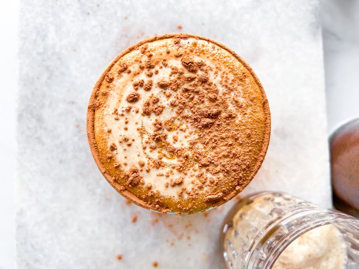 Finished espresso martini mocktail topped with cocoa powder.