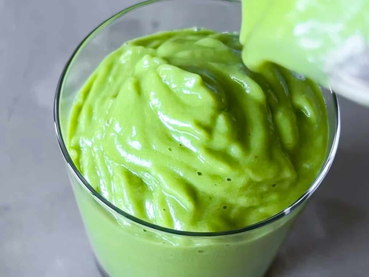 Smoothie being poured into a cup.