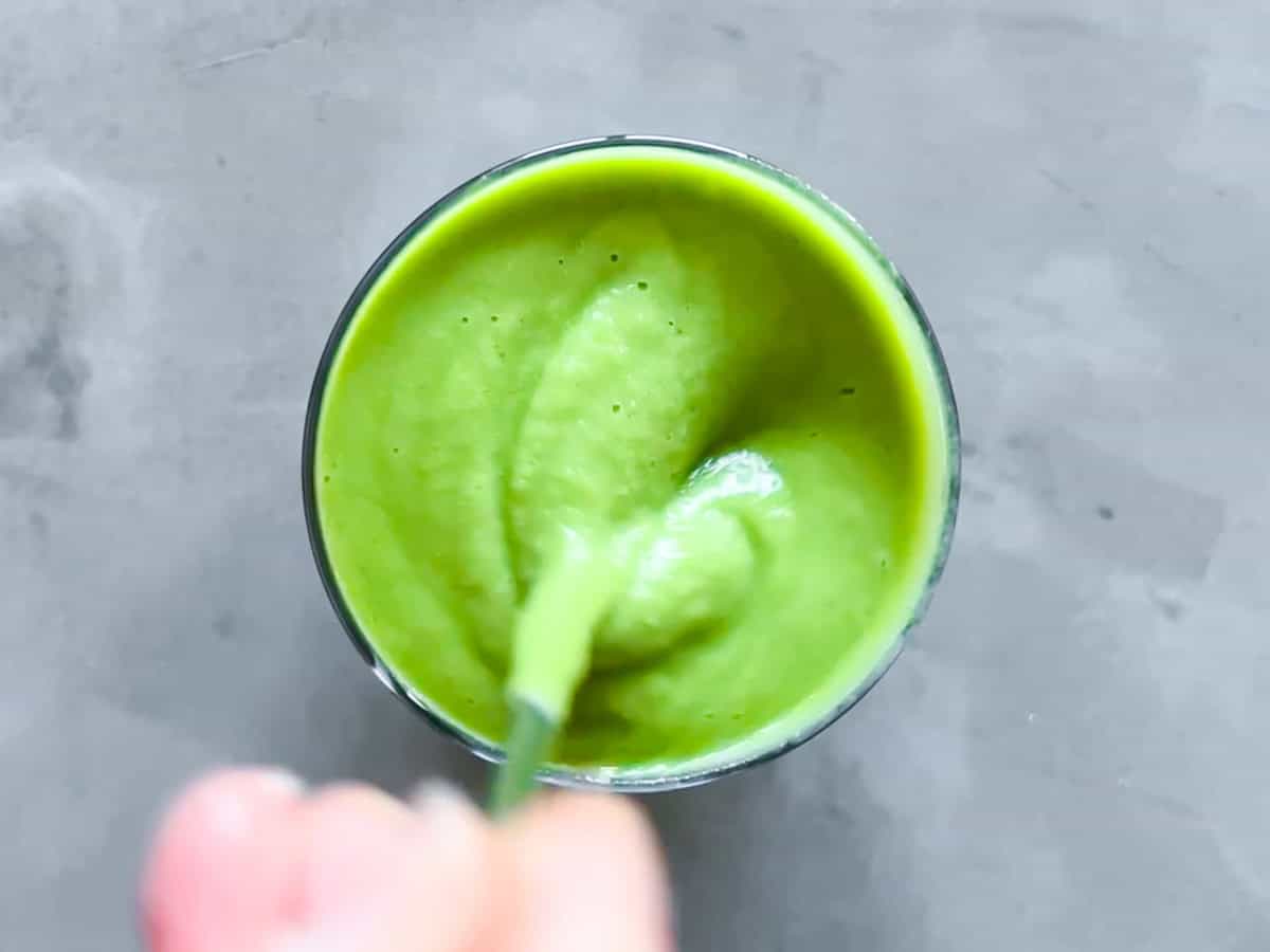 Matcha smoothie being stirred.